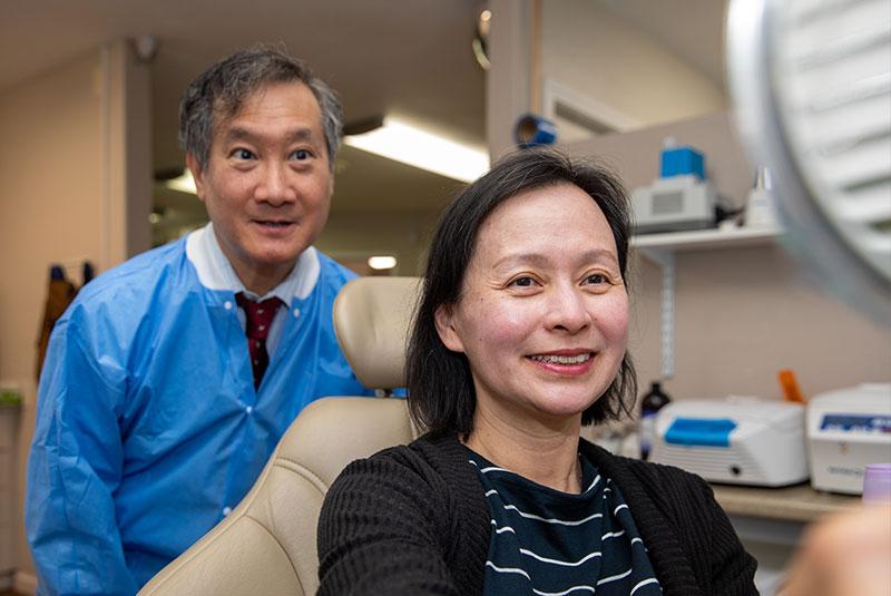 Dr. Gregory Louie with a patient smiling